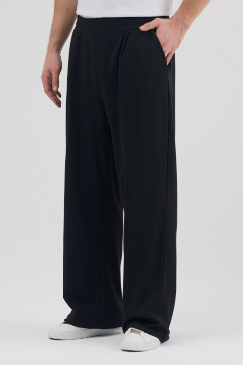 Siyah Dalgıç Kumaş Şardonlu Önü Pile ve Cep Detaylı Rahat Kesim Baggy Pantolon